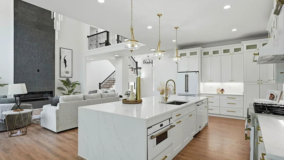 White shaker kitchen island with waterfall quartz countertop opening into a family room